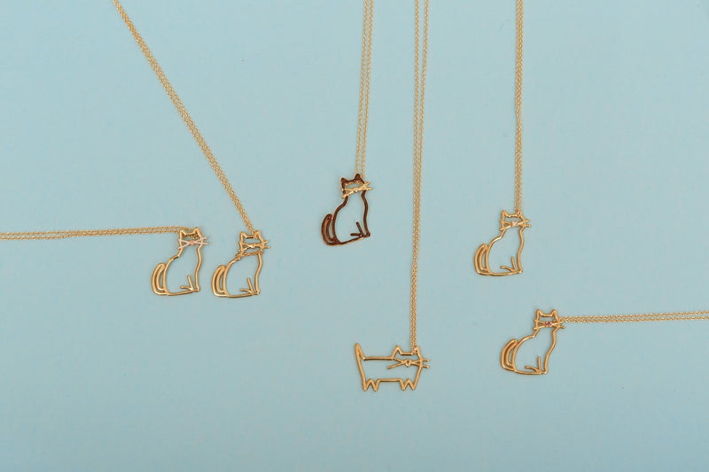 複数の猫の金のネックレスがおかれている